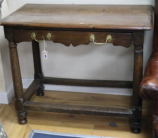 A Cromwellian oak side table, fitted single long drawer with shaped frieze, on gun barrel turned supports W.97cm